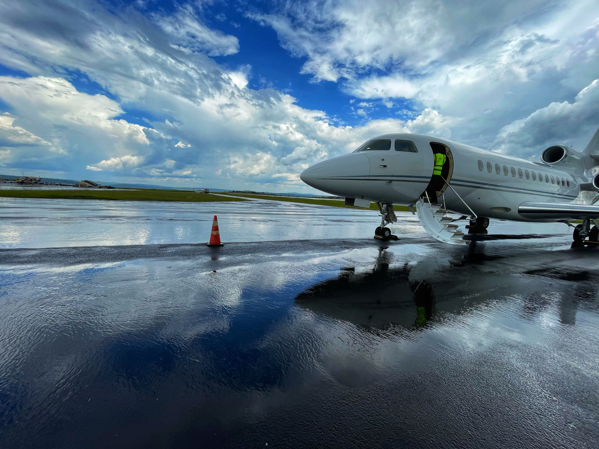 Dassault Falcon on wet ramp with sky reflections