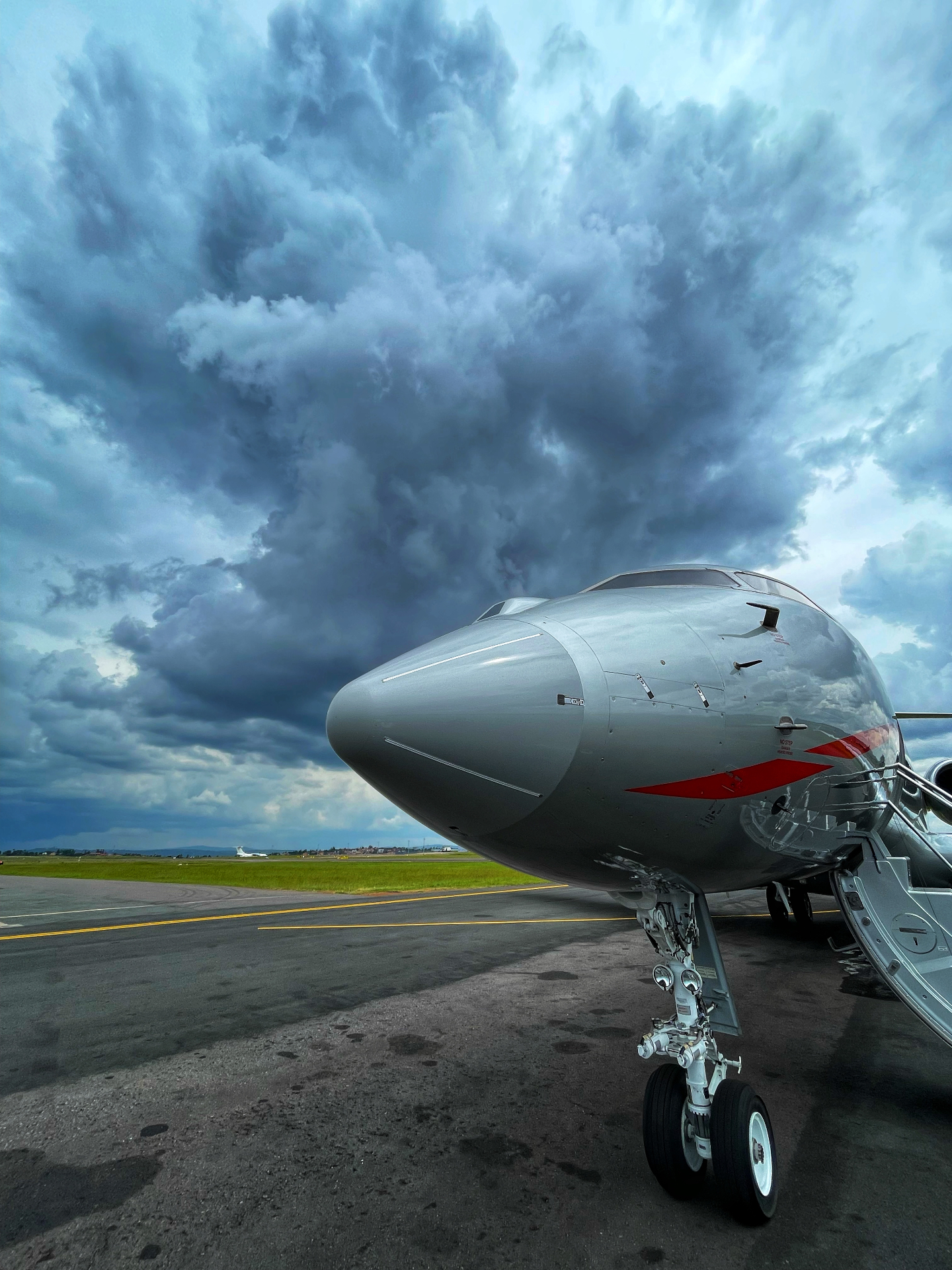 Global Express nose close-up under dramatic storm clouds