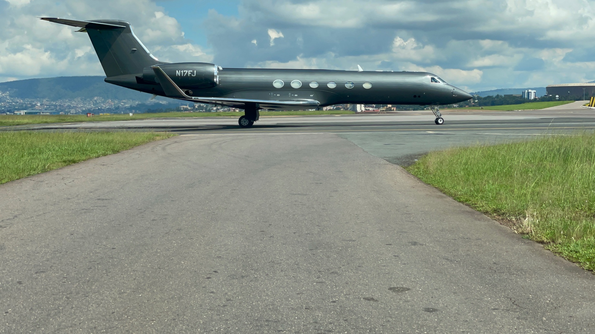 Black Gulfstream profile view on taxiway