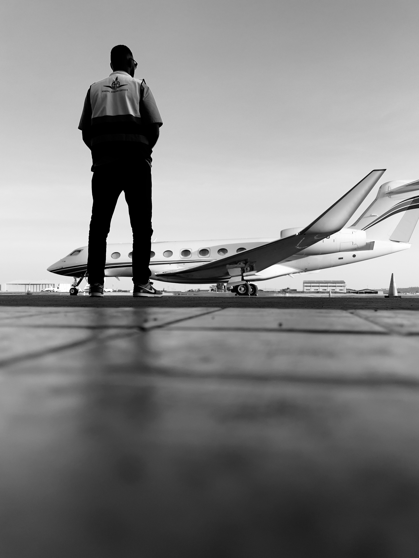 G.A.S. staff overlooking private jet on tarmac